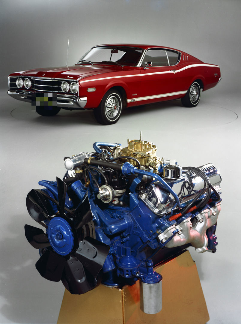Studio composition of a blue-painted Ford 428 Cobra Jet V8 on a stand in the foreground and a red 1968 Mercury Cyclone fastback behind it