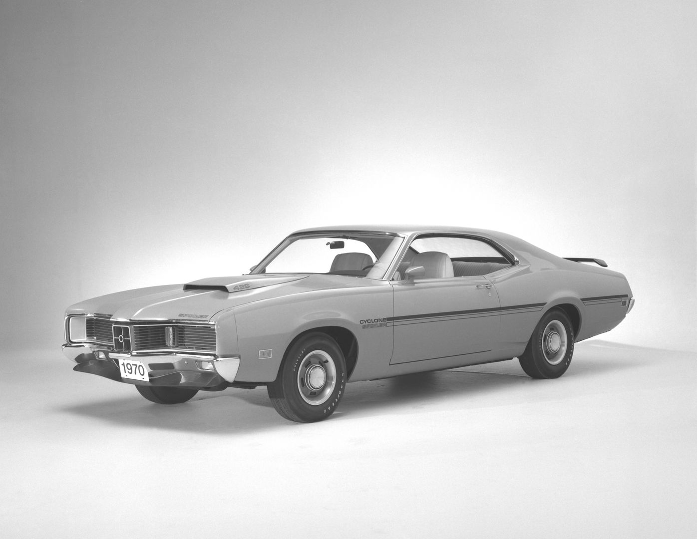 Black-and-white studio photo of a 1970 Mercury Cyclone Spoiler two-door hardtop, front three-quarter view, showing the gunsight grille, hood scoop with 429 label and rear wing