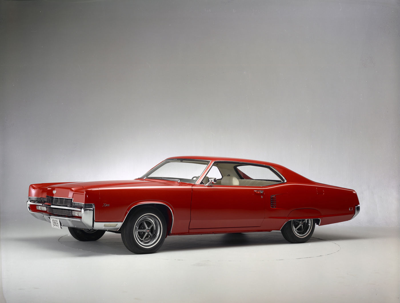 Red 1969 Mercury Marauder X-100 two-door hardtop with concealed headlights and styled steel wheels, front three-quarter studio view