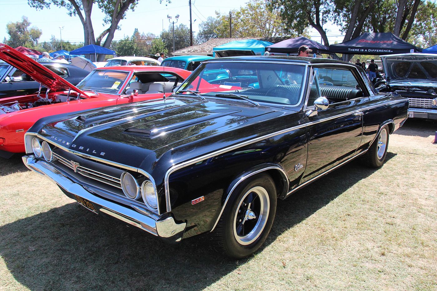 Black 1964 Oldsmobile Cutlass 4-4-2 two-door hardtop, front three-quarter, at a car show