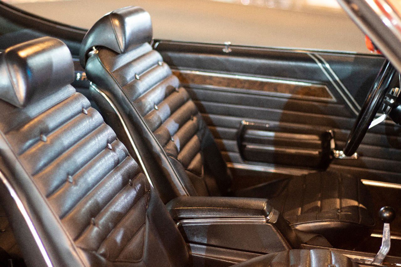 Black vinyl bucket seats and door panel of a 1970 Oldsmobile 4-4-2