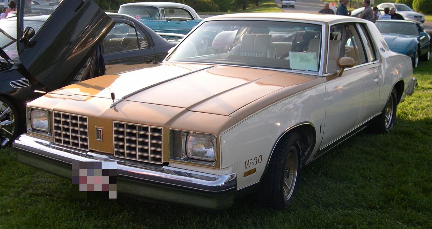 Gold-and-white 1979 Hurst/Olds W-30 coupe, front three-quarter, at a car show