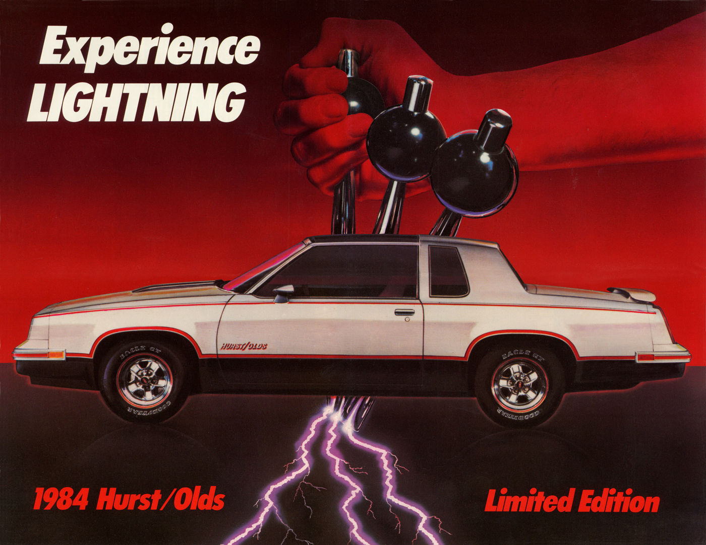 Folder spread: silver-and-black 1984 Hurst/Olds in side view under the three-lever Lightning Rods shifter and a lightning bolt