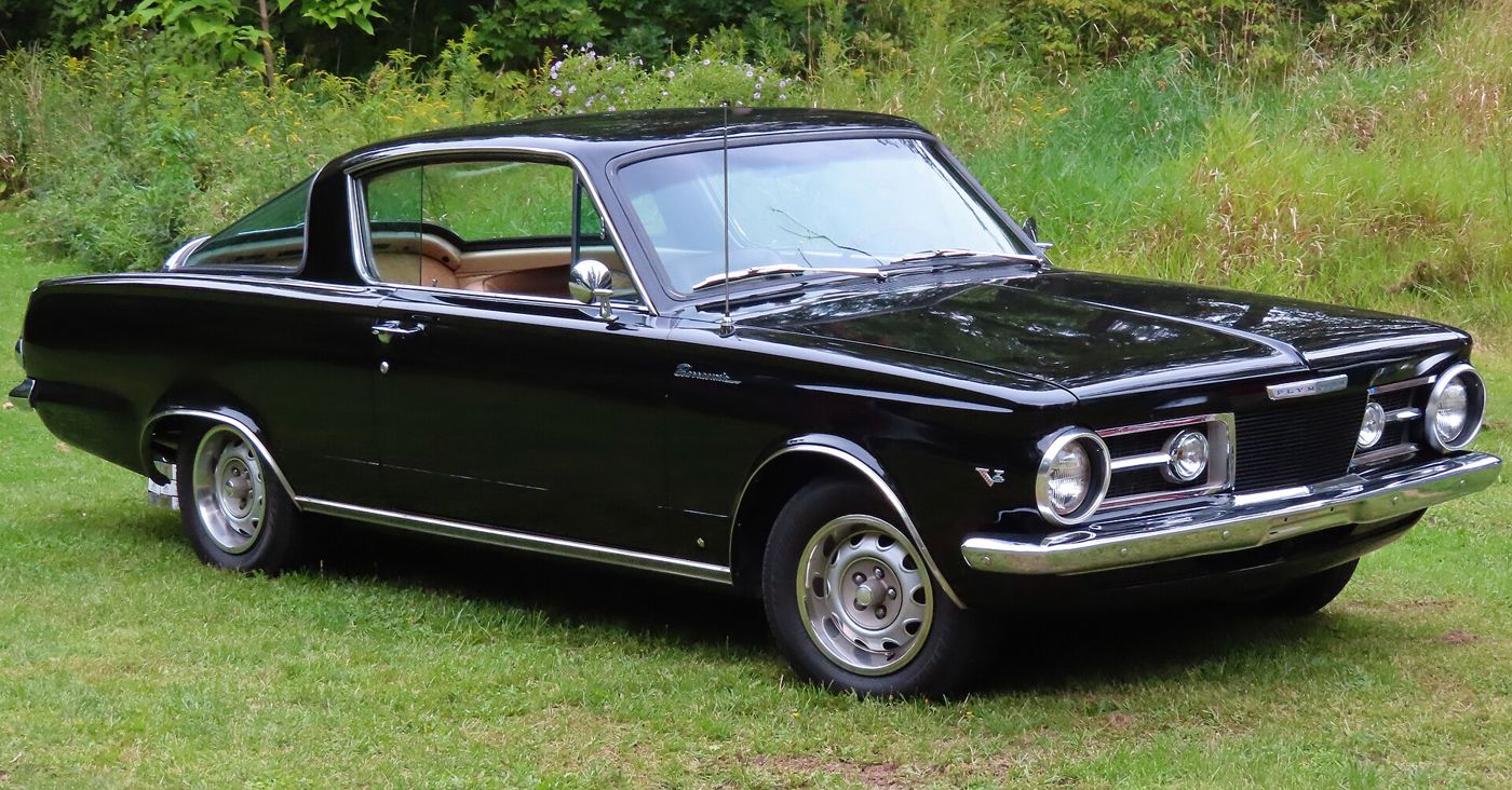 Black 1964 Plymouth Barracuda from the front three-quarter, showing its Valiant-derived front end and long fastback roof