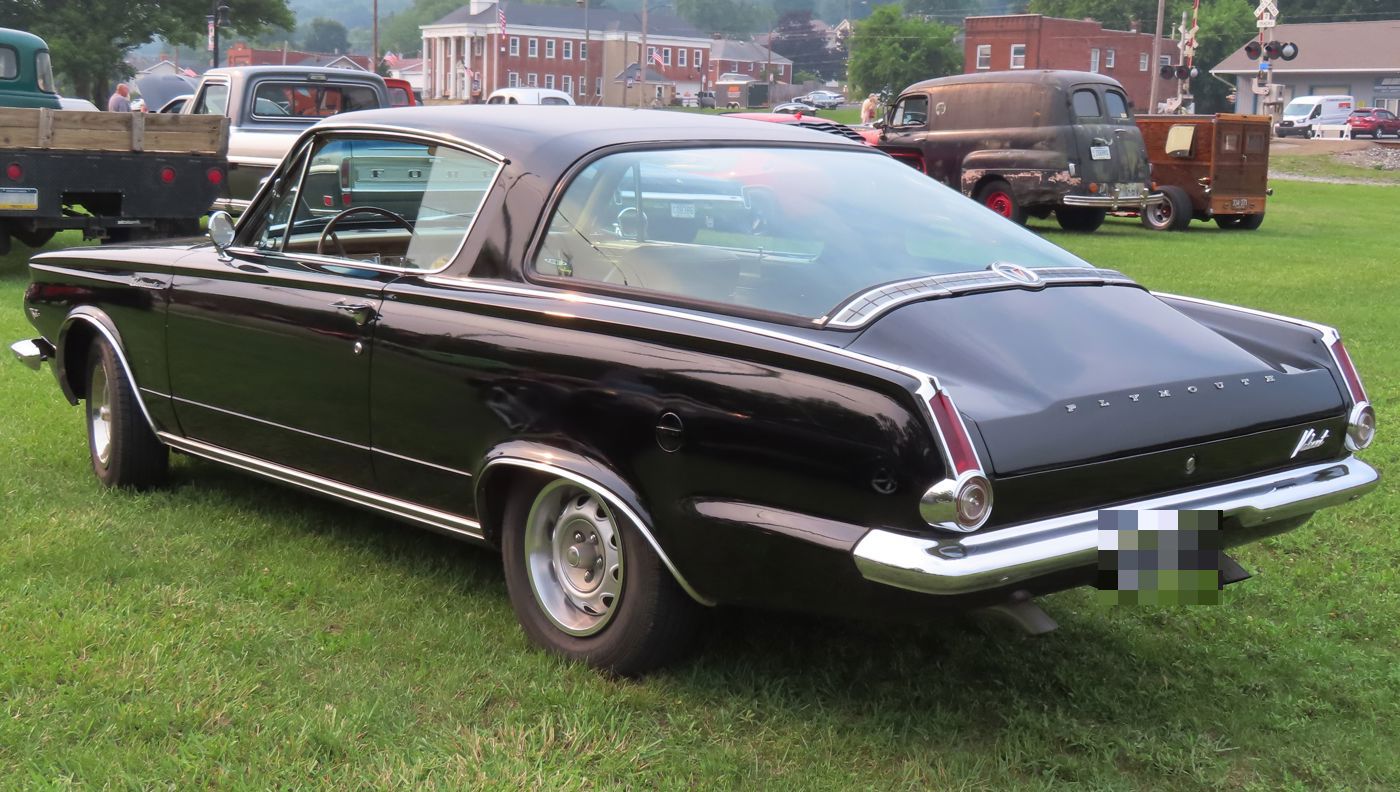 Black 1964 Plymouth Barracuda from the rear three-quarter with its large curved glass rear window