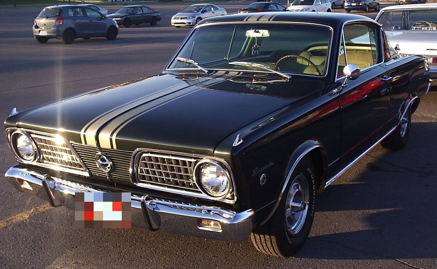 Black 1966 Plymouth Barracuda with twin gold hood stripes and the egg-crate grille with a centre fish emblem