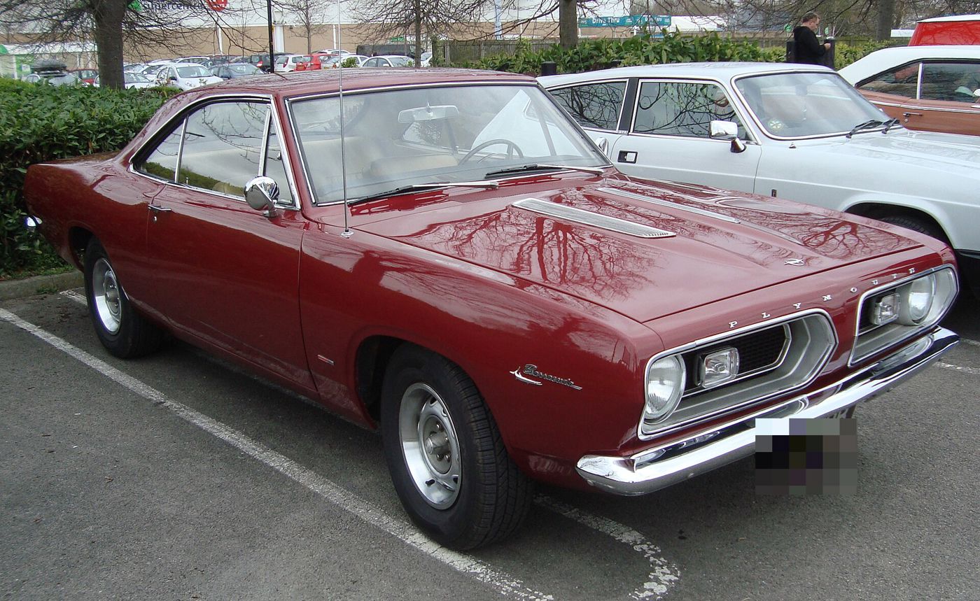Dark red 1967 Plymouth Barracuda notchback hardtop with the split grille and hood louvres, front three-quarter