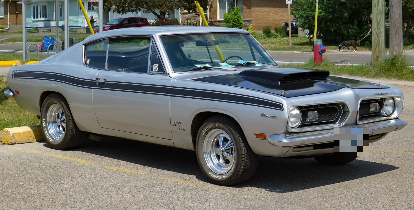 Silver 1969 Plymouth Cuda 440 fastback with black side stripes, 440 callout and twin hood scoops