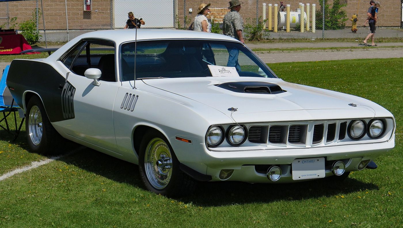 White 1971 Plymouth Cuda with black billboard stripe, four headlamps, gilled front fenders and Shaker scoop