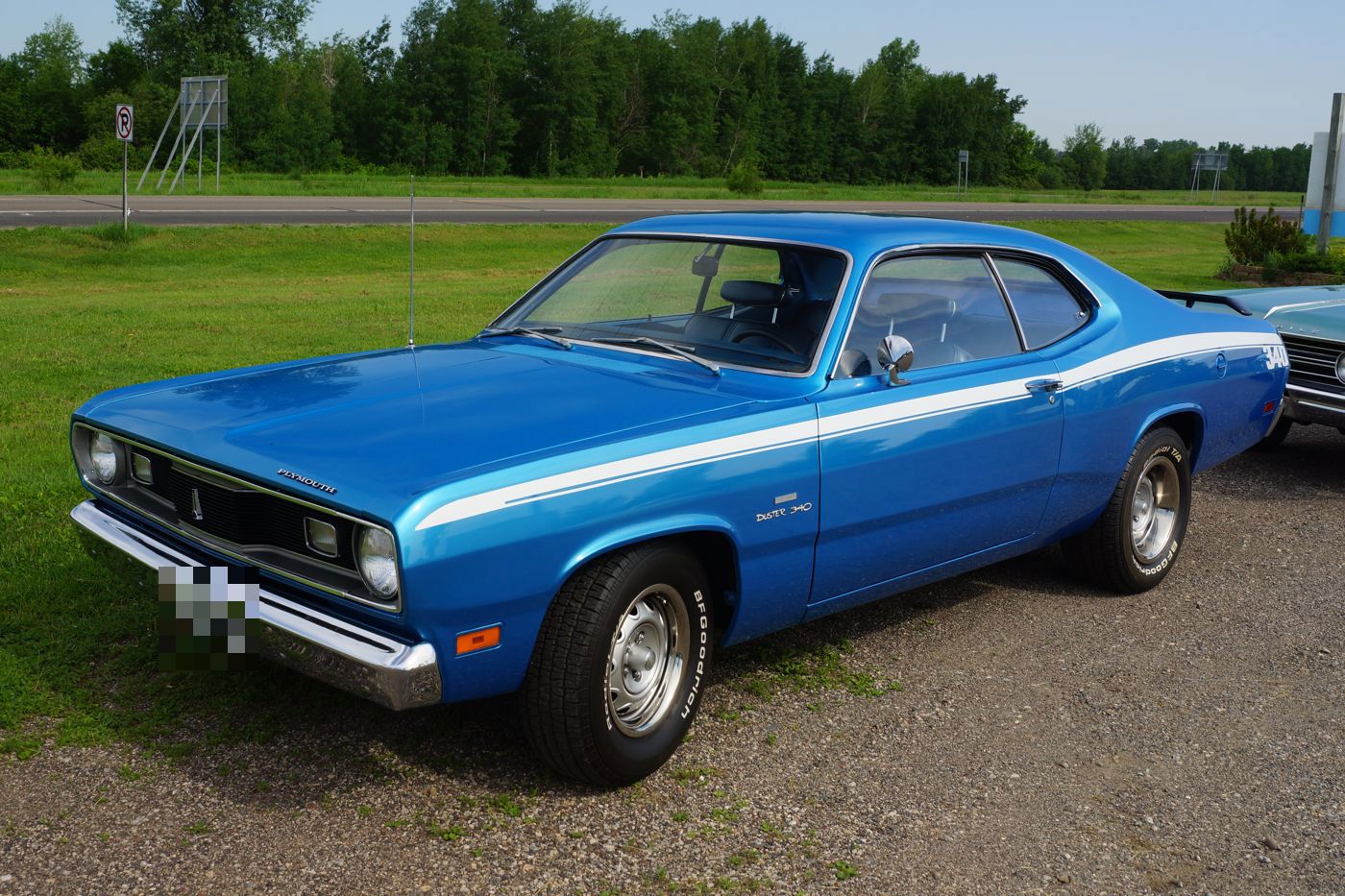 Blue 1970 Plymouth Duster 340 coupe with a white side stripe and Duster 340 fender script, front three-quarter
