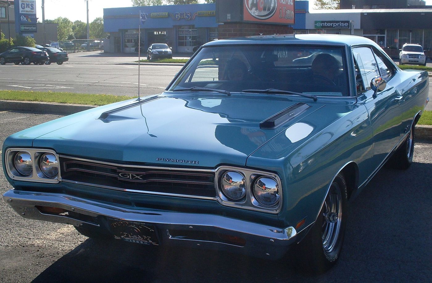 Blue 1969 Plymouth GTX close from the front three-quarter, with the GTX grille badge and hood vents