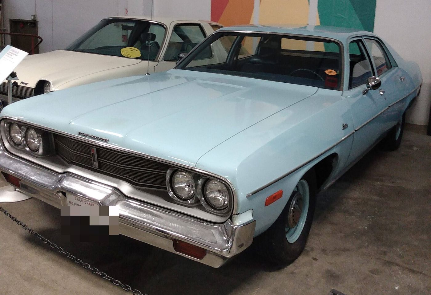 Light blue 1974 Plymouth Satellite four-door sedan in a museum display