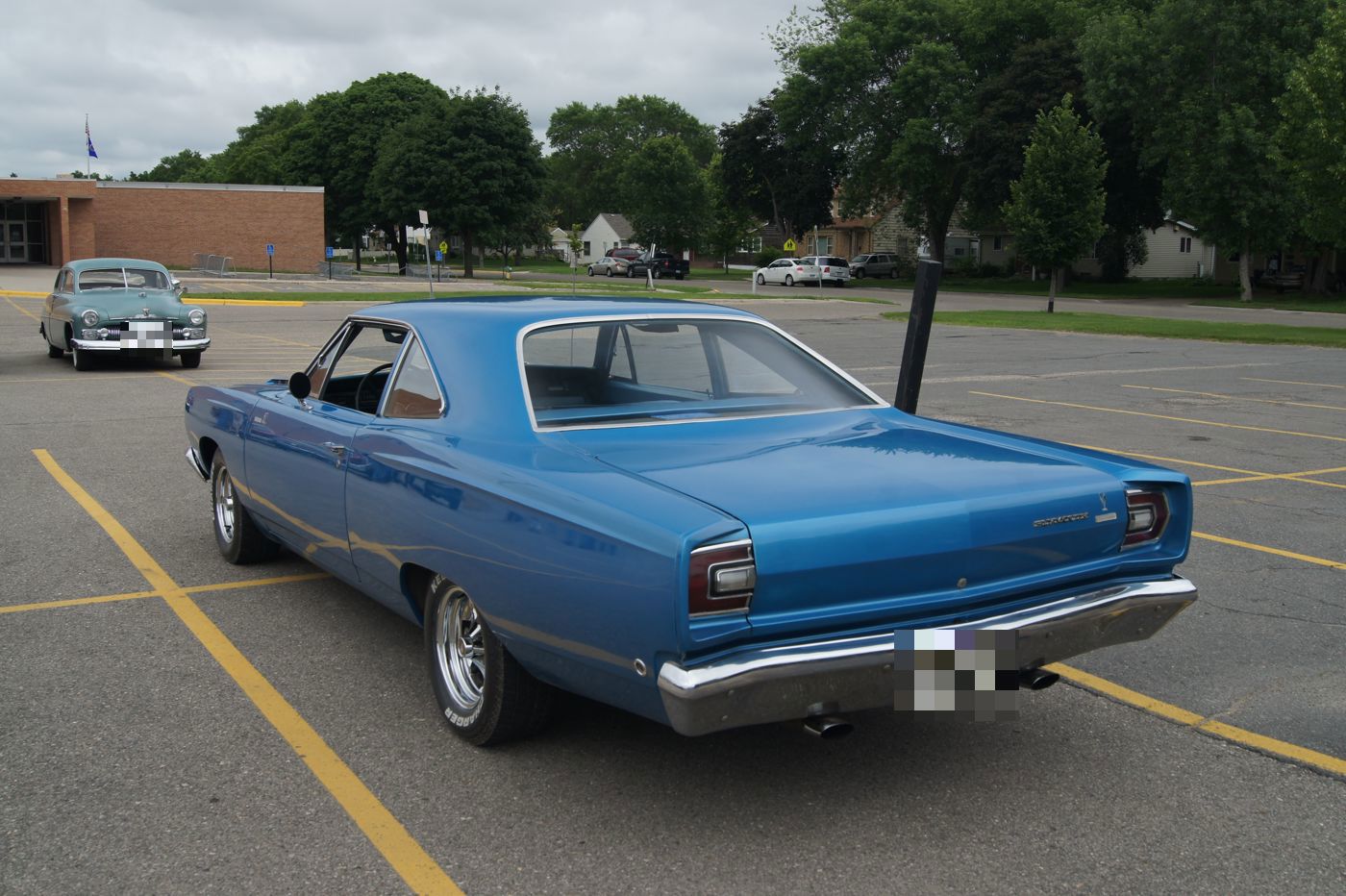 Blue 1968 Plymouth Road Runner in a parking lot, rear three-quarter view