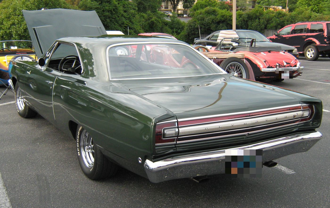 Dark green 1968 Plymouth Road Runner from the rear, showing its full-width tail panel and pillared coupe roof