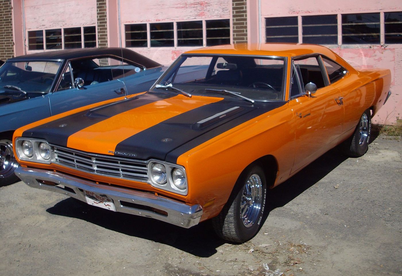 Orange 1969 Plymouth Road Runner with black hood stripes and the 1969 split grille, front three-quarter