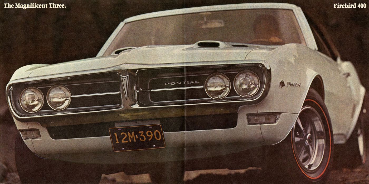 Close front view of a white 1968 Firebird 400 with dual hood scoops, quad headlamps and redline tires, under the heading The Magnificent Three
