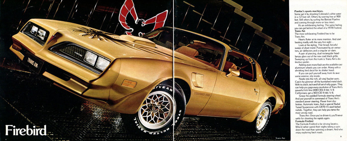 Gold 1978 Trans Am with hood bird and snowflake wheels in close front three-quarter view, under a large Firebird emblem