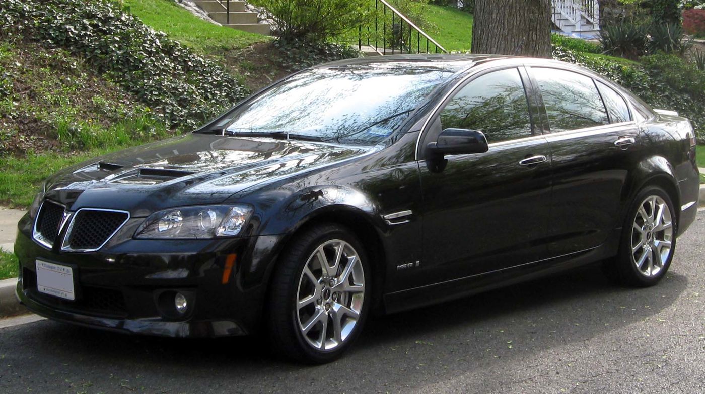 Black 2009 G8 GXP sedan parked at a curb, seen from the front three-quarter