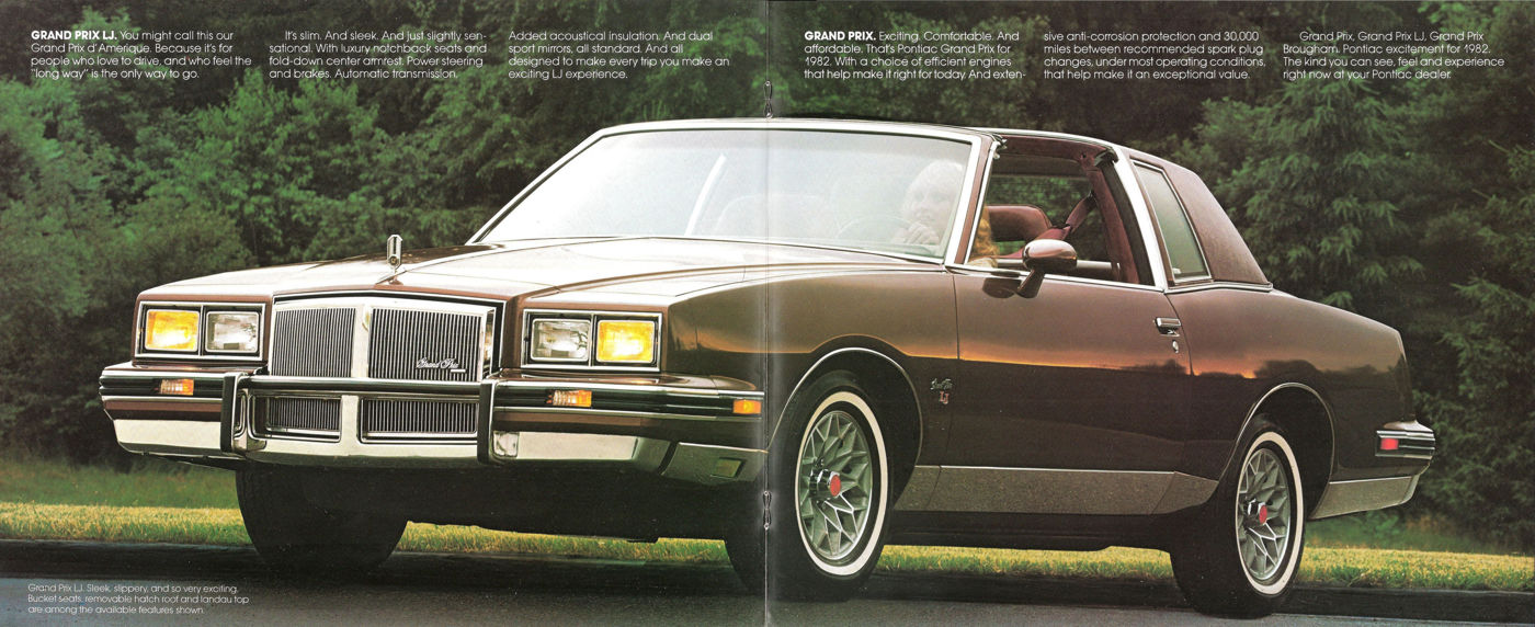 Brown 1982 Grand Prix LJ coupe with its egg-crate grille and wire-style wheels, front three-quarter on grass beside trees
