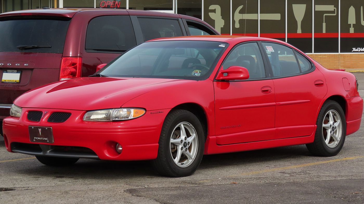 Red 1999 Grand Prix GT sedan front three-quarter in a parking lot