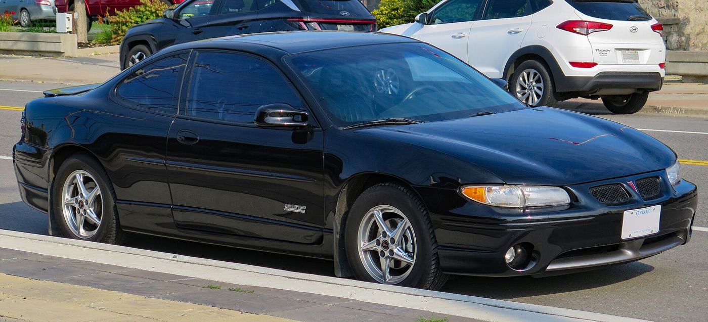 Black 2000 Grand Prix GTP coupe, front three-quarter at a curb
