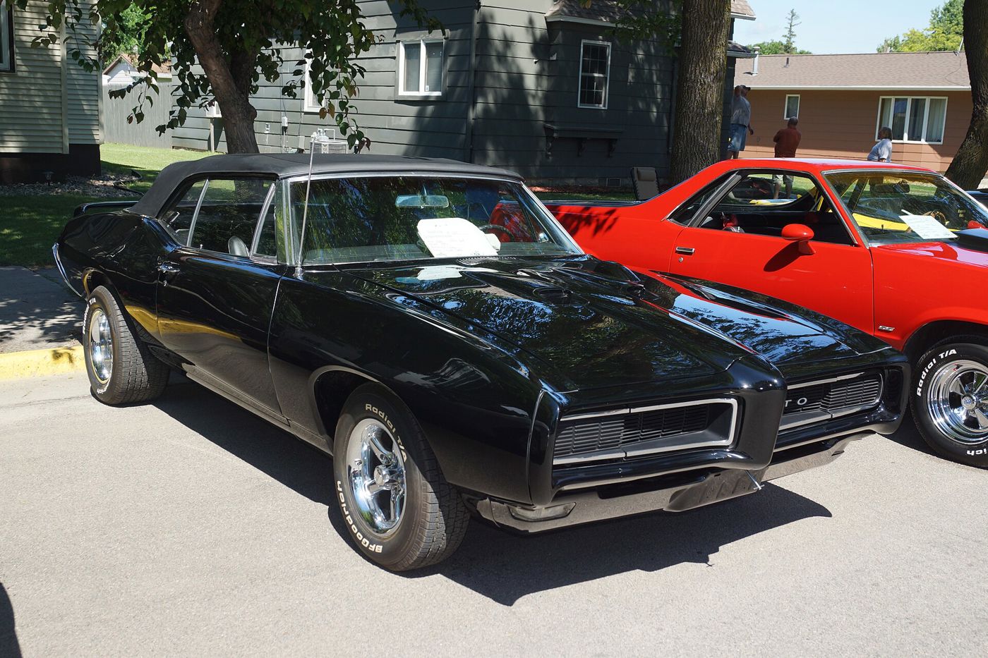 Black 1968 GTO hardtop with its body-color Endura front bumper and hood scoop, front three-quarter on a street