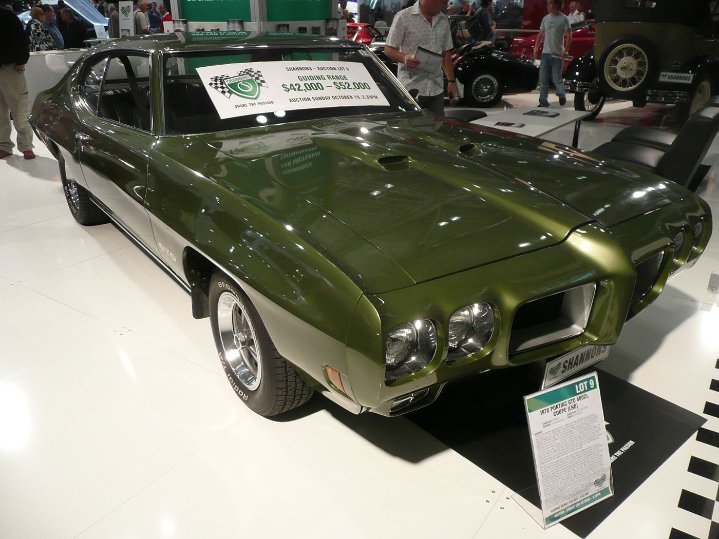 Green 1970 GTO hardtop with its Endura nose and twin round headlamps, front three-quarter on an auction stand with a lot sign