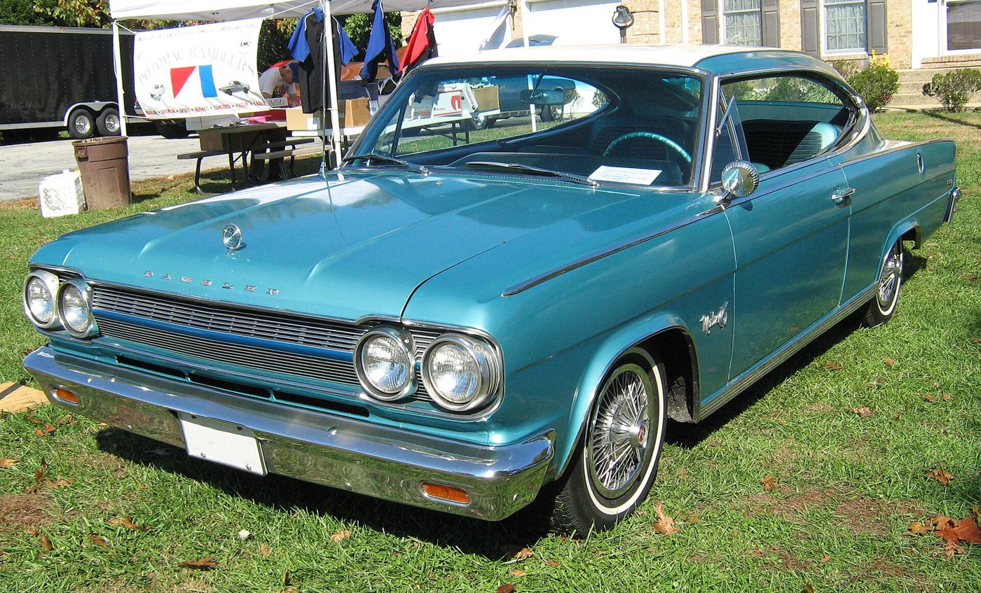 Aqua 1965 Rambler Marlin fastback with white roof, twin headlamps and wire wheel covers, at a club show