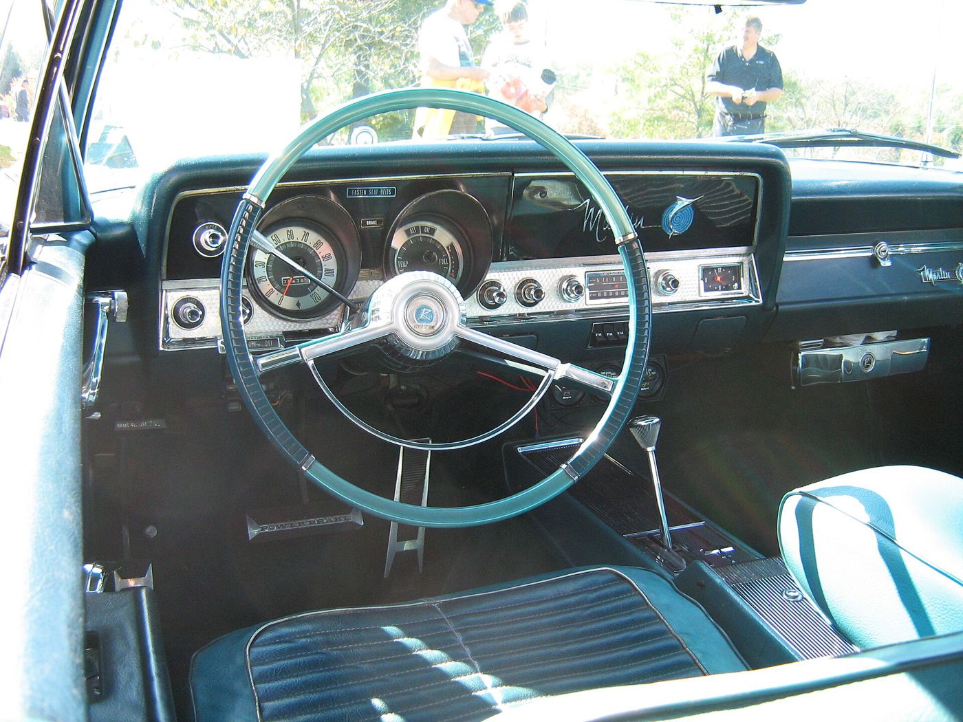 Aqua interior of a 1965 Marlin with two-tone steering wheel, instrument panel and bucket seats with console