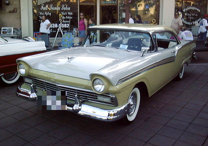 Pale yellow and ivory 1957 Ford Fairlane 500 two-door hardtop, front three-quarter on a street show