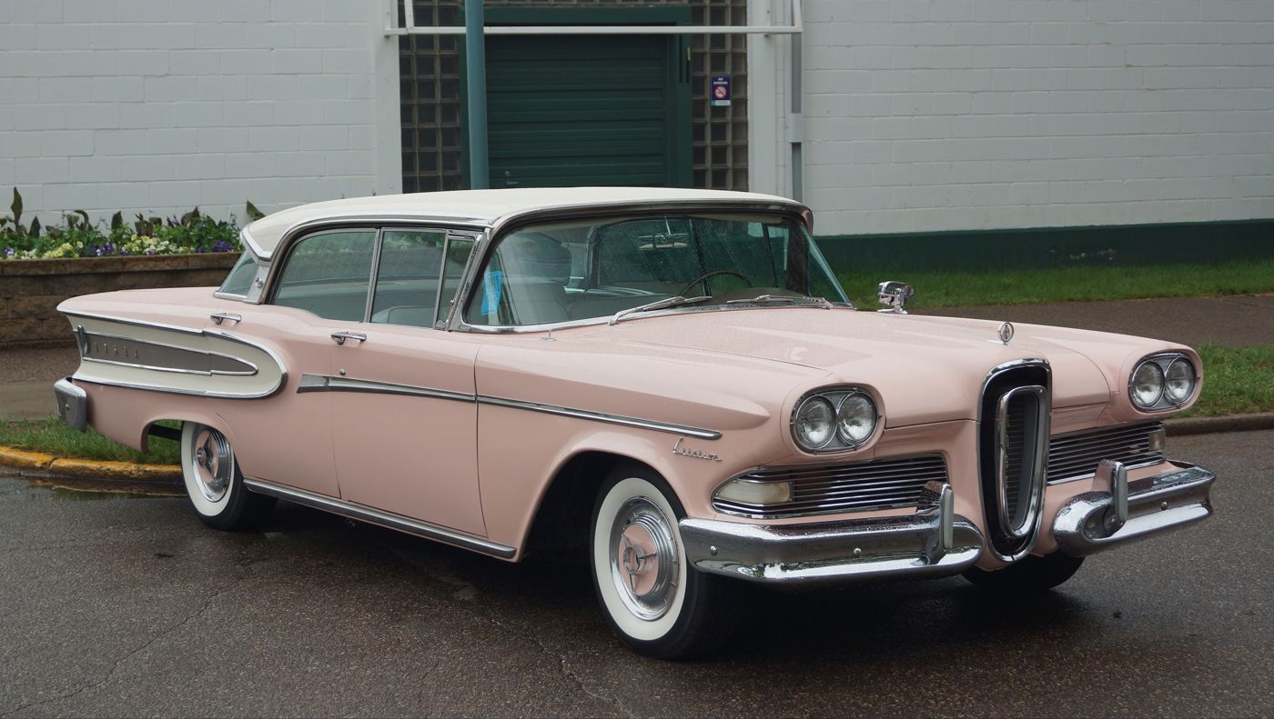 Pink 1958 Edsel Citation four-door hardtop with a white roof in front three-quarter view, showing the vertical horse-collar grille and Citation script on the front fender