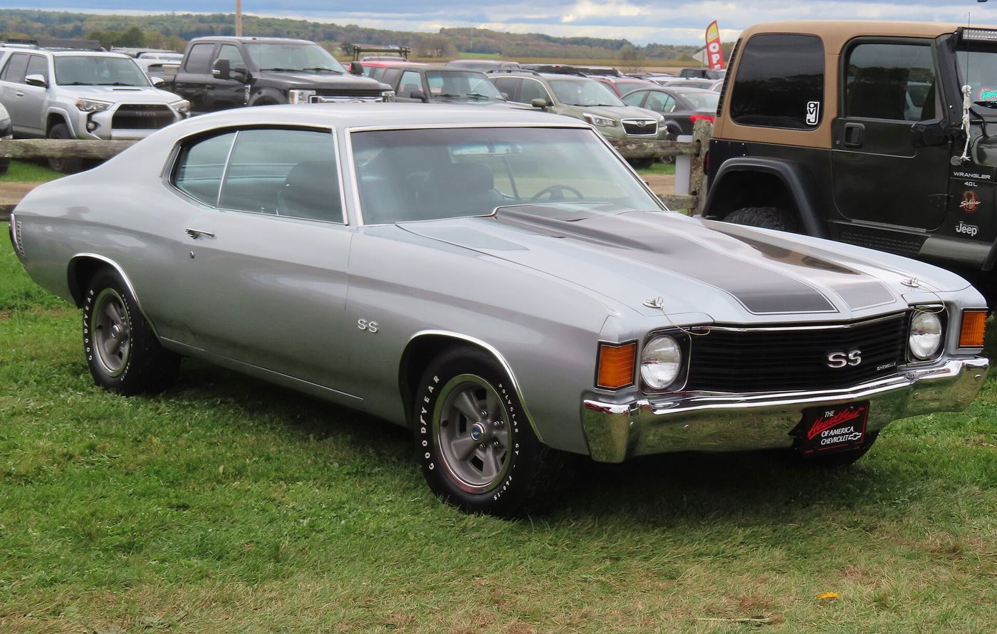 Silver 1972 Chevrolet Chevelle SS with black hood stripes and SS grille badge, front three-quarter on grass