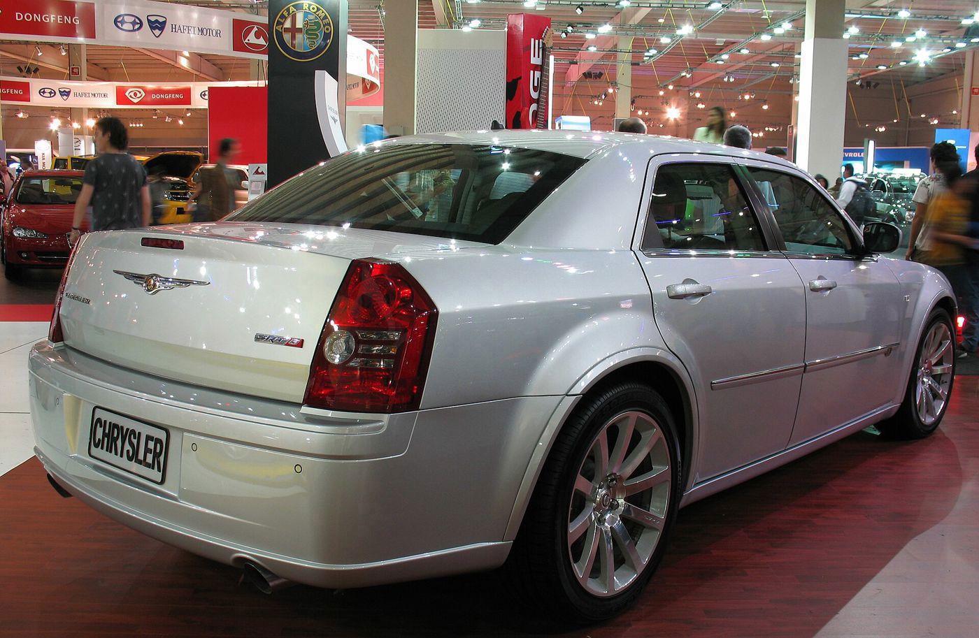 Silver Chrysler 300C SRT8 sedan with SRT8 decklid badge on an auto show stand