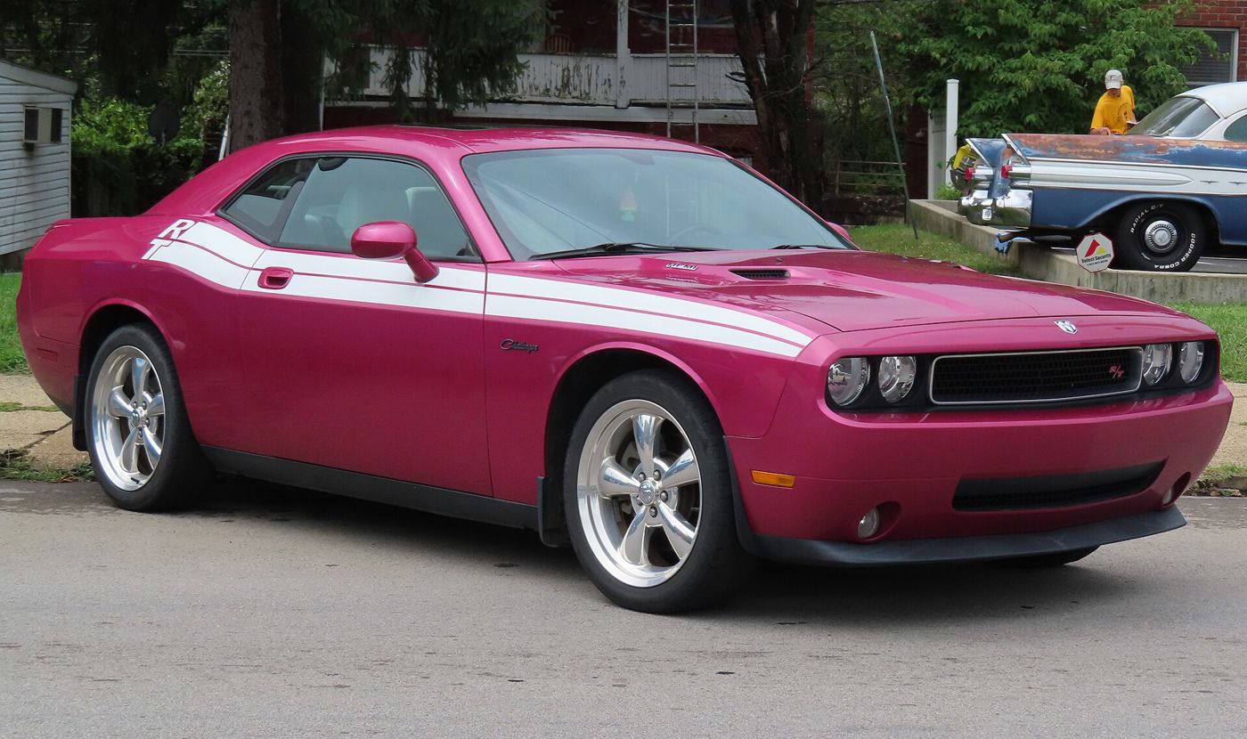 Pink-purple 2010 Dodge Challenger R/T with white R/T side stripe and hood stripes, front three-quarter on a street