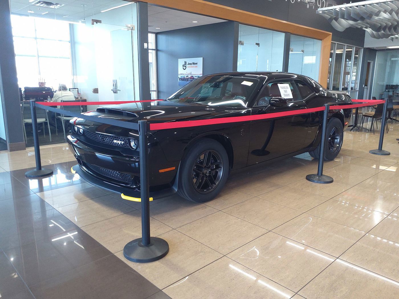 Black 2023 Challenger SRT Demon 170 roped off on a dealership showroom floor
