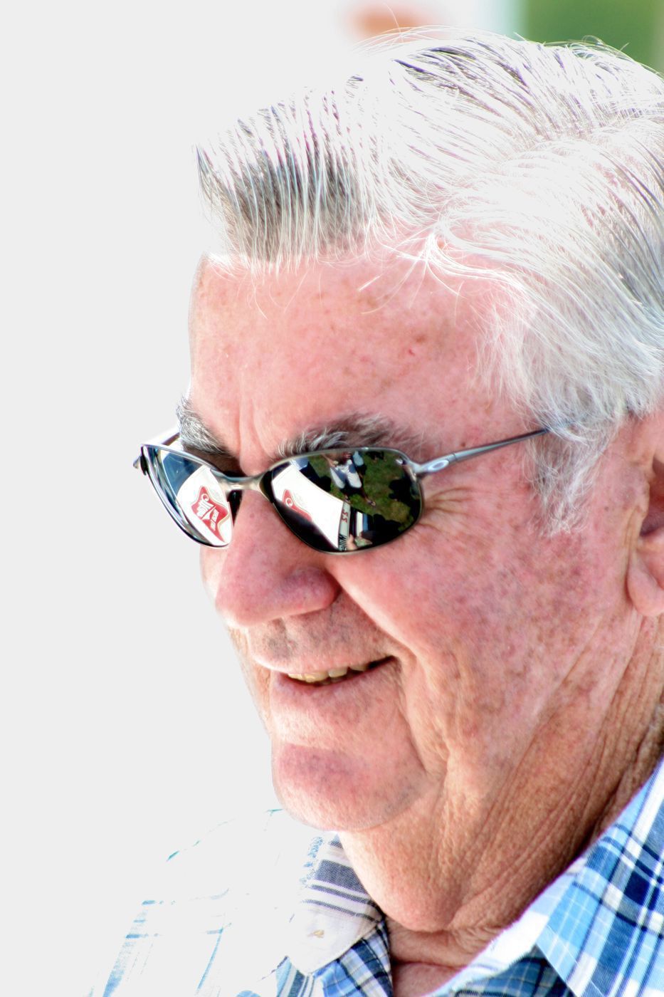 Close portrait of Bobby Allison in sunglasses and a plaid shirt