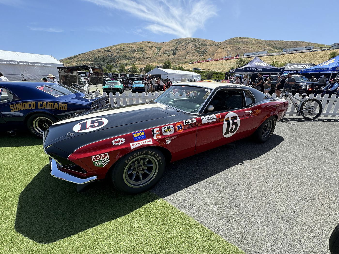 Red and black 1969 Boss 302 Trans-Am race car number 15 with sponsor decals, displayed at Sonoma Raceway