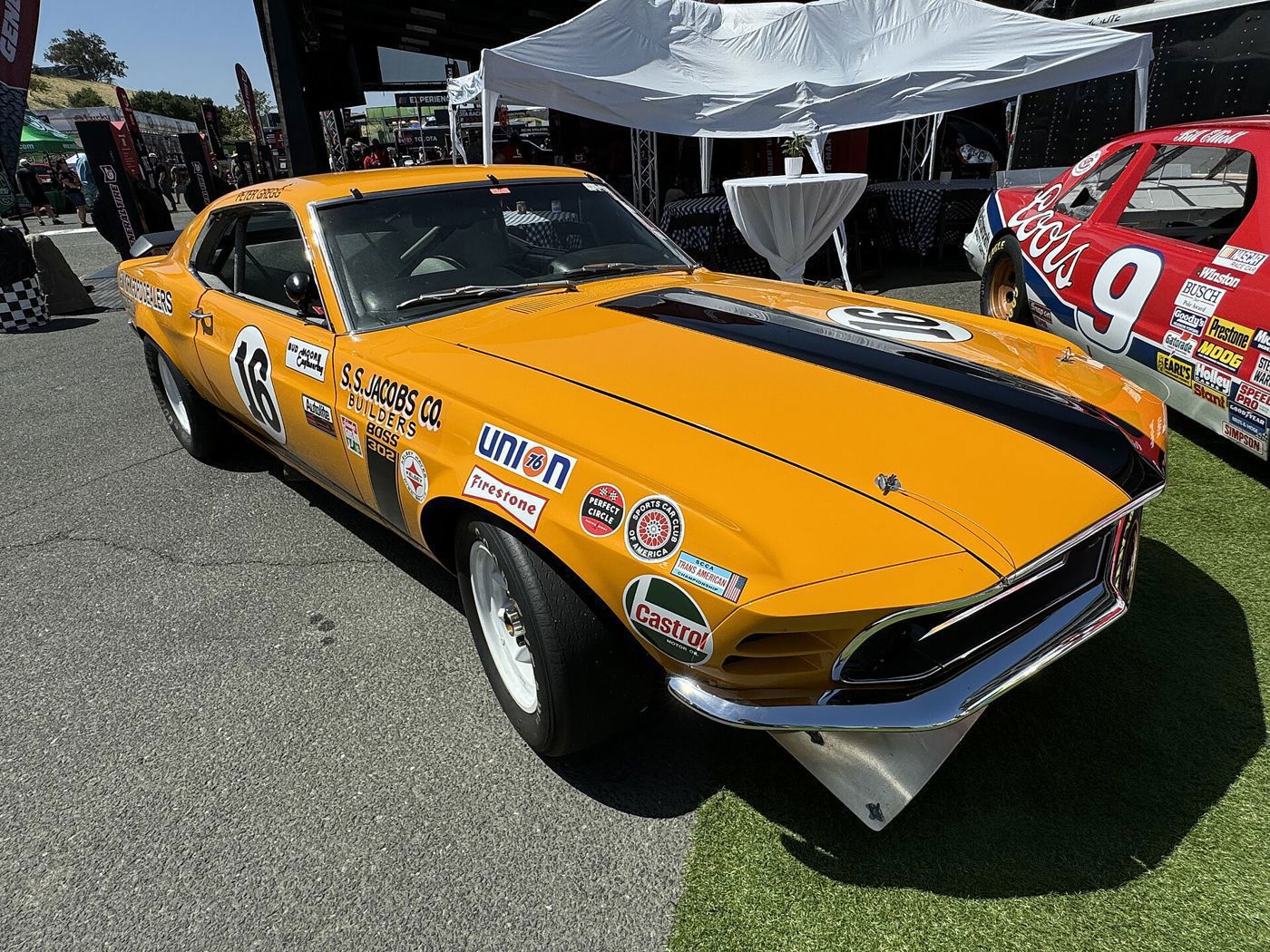 Orange 1970 Boss 302 Trans-Am car number 16 with S.S. Jacobs and sponsor decals, displayed at Sonoma Raceway