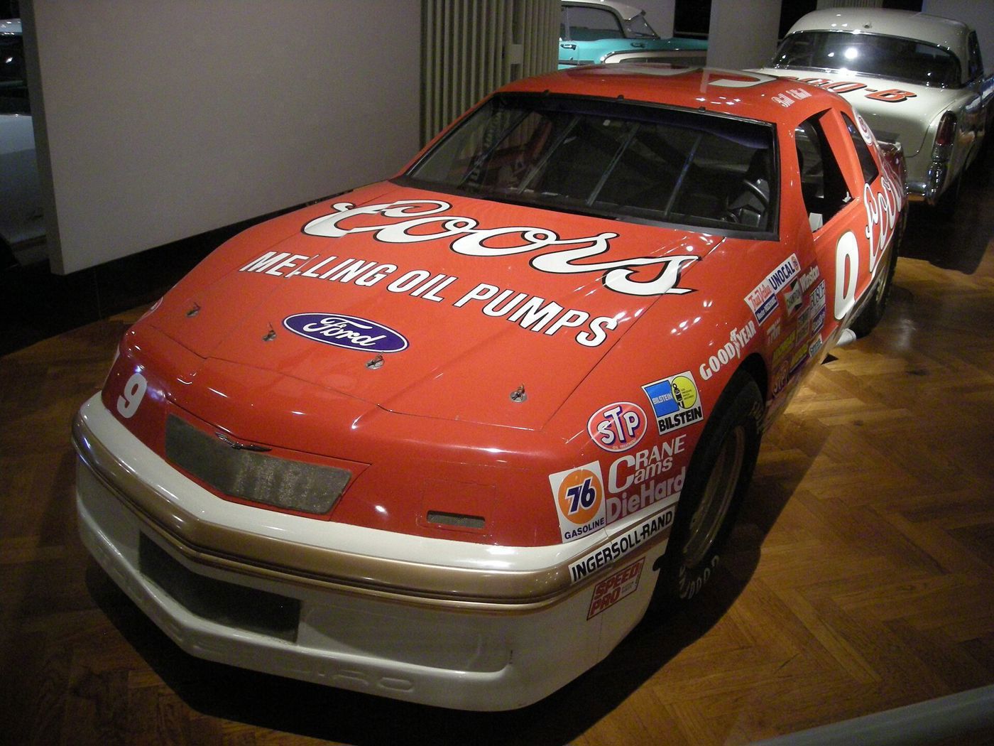 Red and white Coors / Melling number 9 Ford Thunderbird NASCAR car on display in a museum