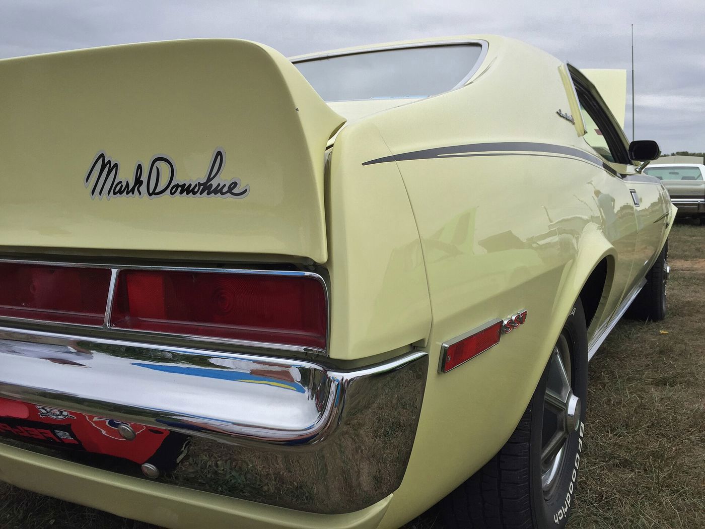 Pale yellow 1970 AMC Javelin rear deck with a tall ducktail spoiler carrying a Mark Donohue signature decal