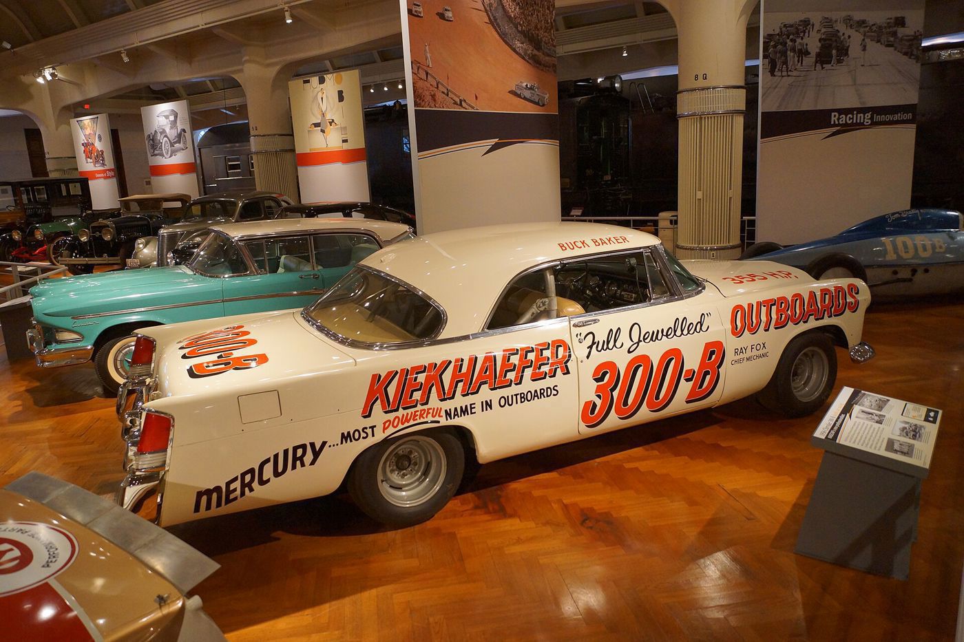 White 1956 Chrysler 300-B race car with Kiekhaefer Mercury Outboards lettering and number 500-B in a museum