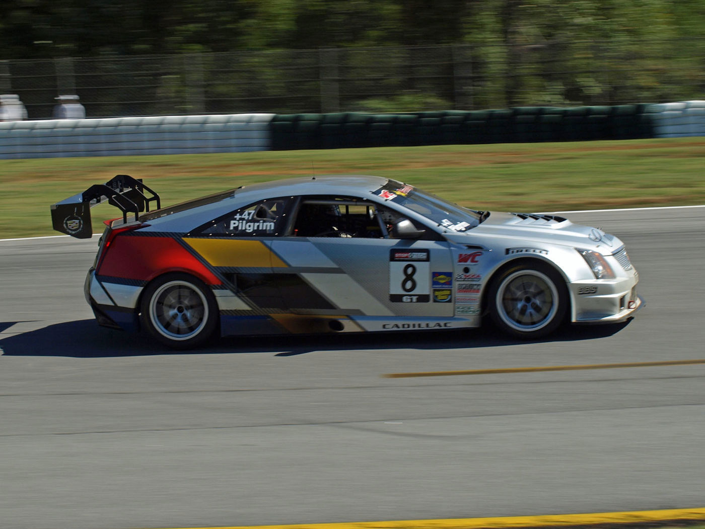 Silver Cadillac CTS-V coupe race car number 8 with Pilgrim on the window, on track