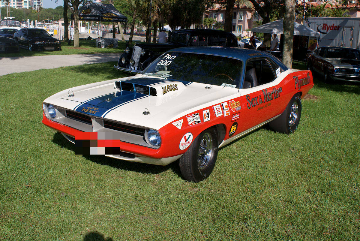 Red, white and blue Plymouth Cuda drag car with Sox & Martin lettering and 426 Hemi hood decal on grass