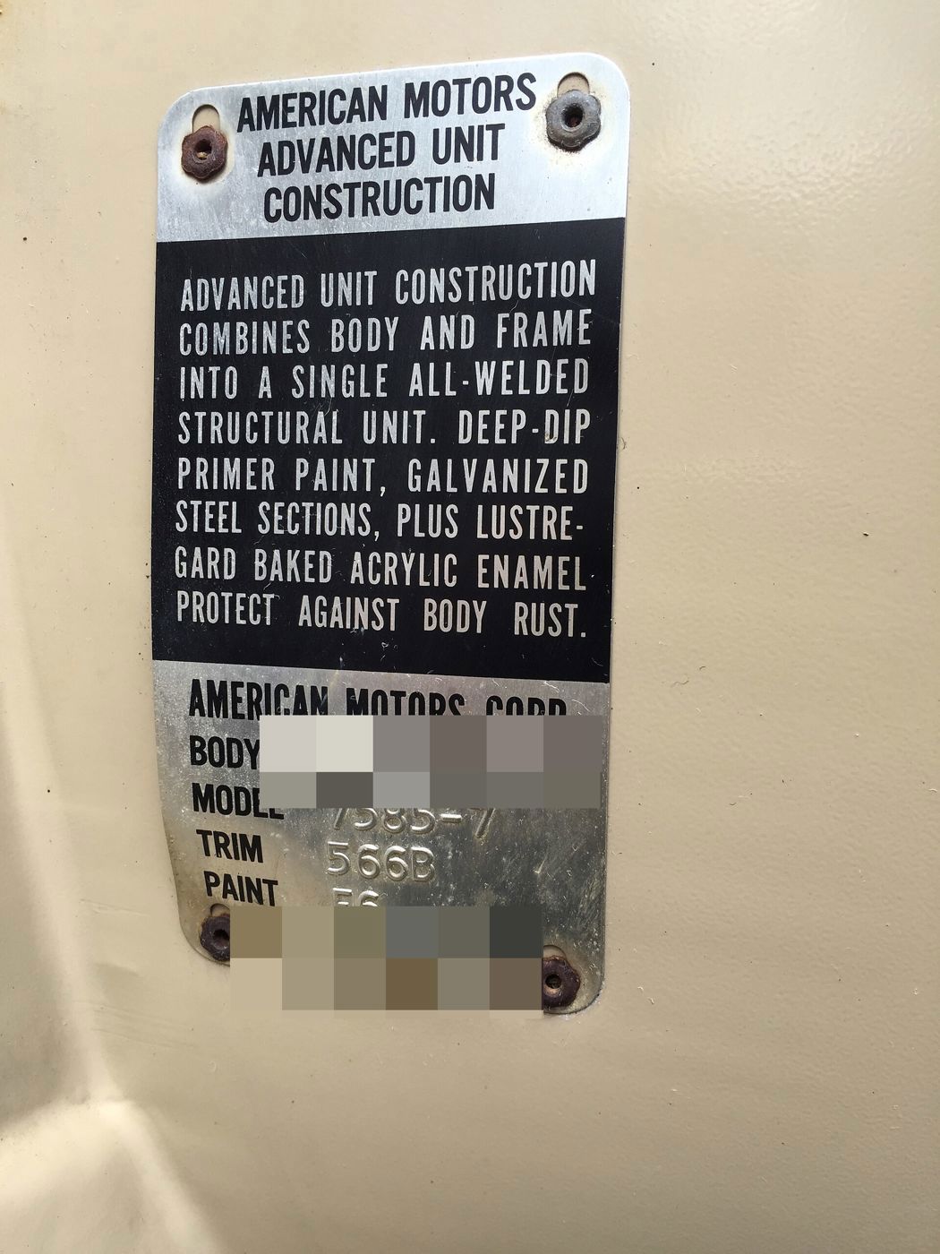 Aluminum plate on a beige door reading American Motors Corp. with stamped body number, model 7585-7, trim and paint codes