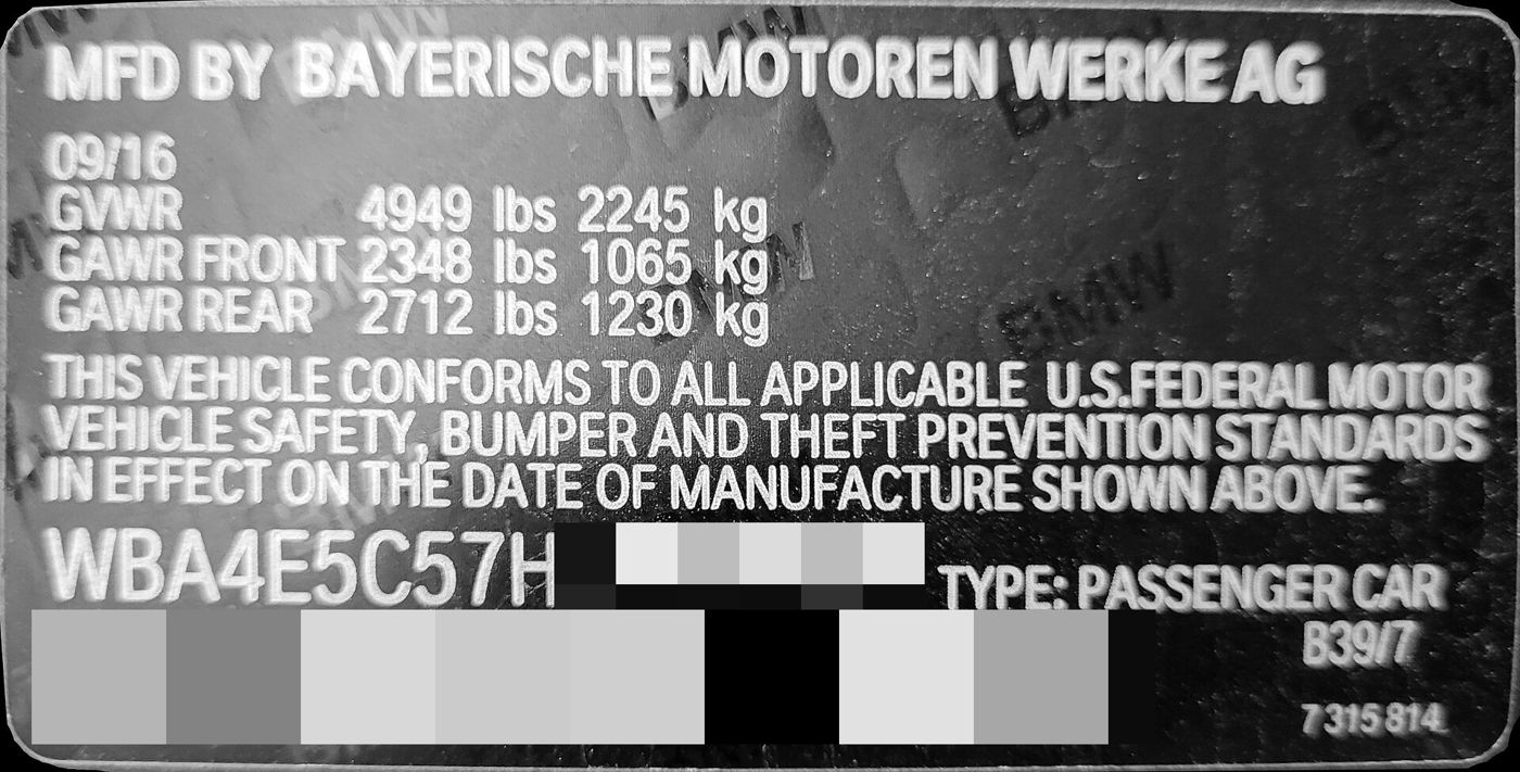 Black certification label with GVWR figures, a federal standards statement, a 17-character VIN and a barcode