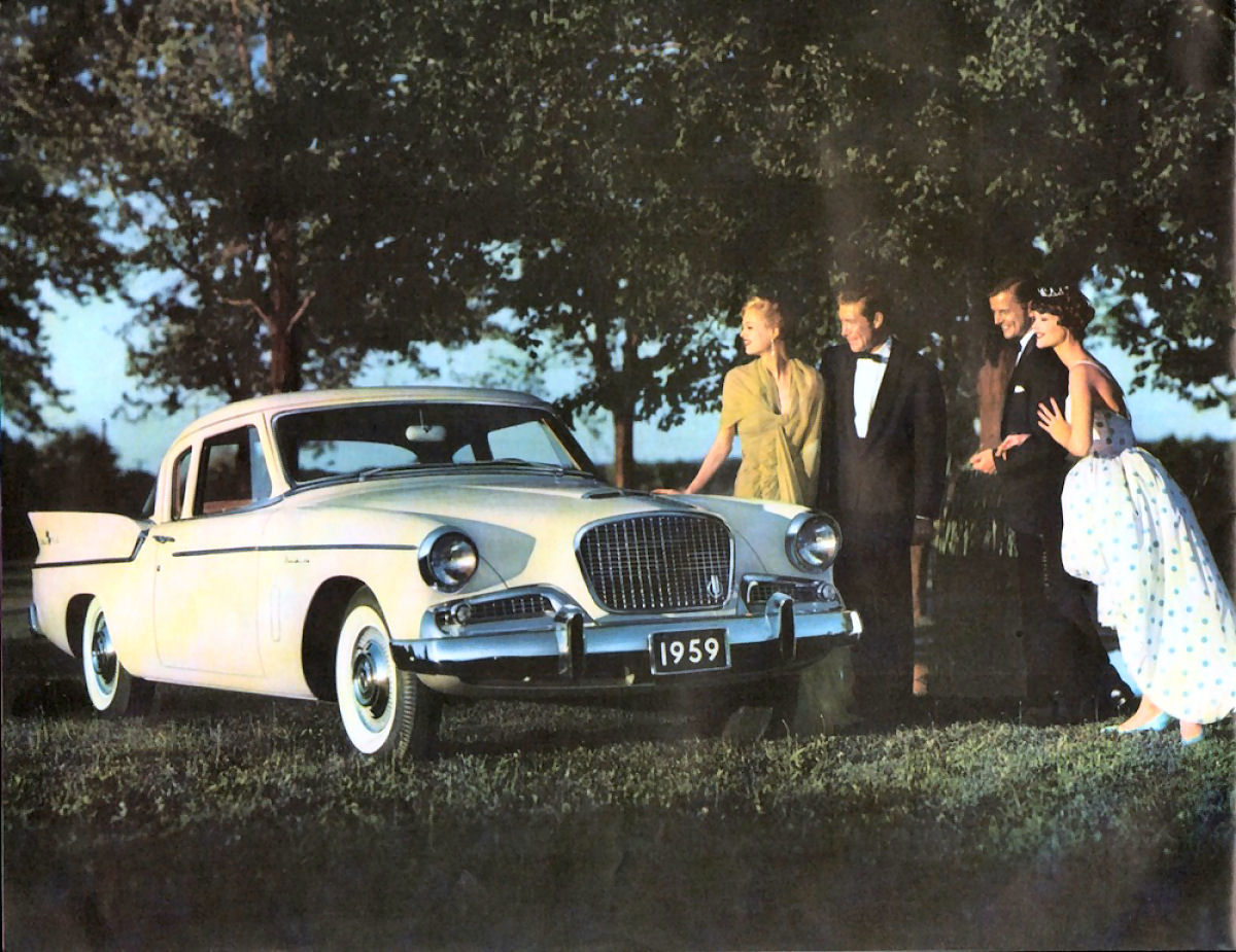 Brochure photo of a white 1959 Studebaker Silver Hawk with a 1959 placard, people in evening dress beside it