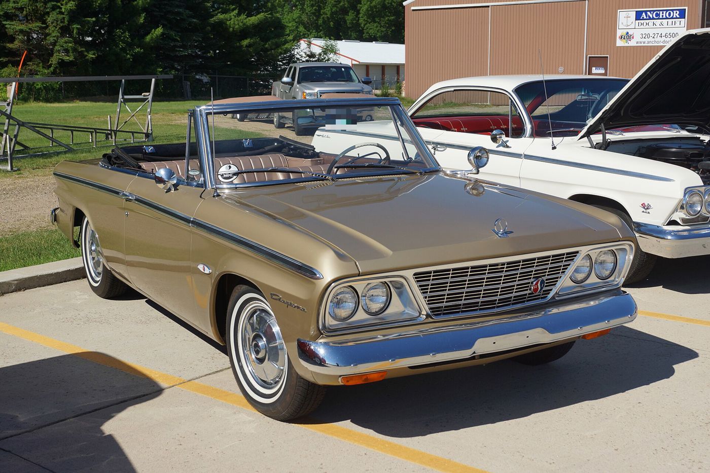 Gold 1964 Studebaker Daytona convertible with the top down, front three-quarter, showing the R1 emblem in its grille and the Daytona fender script
